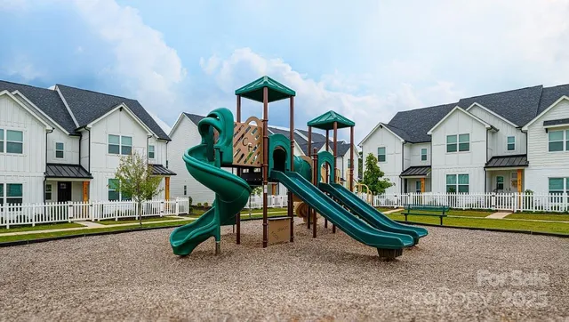 a childrens park with lots of swings and slides