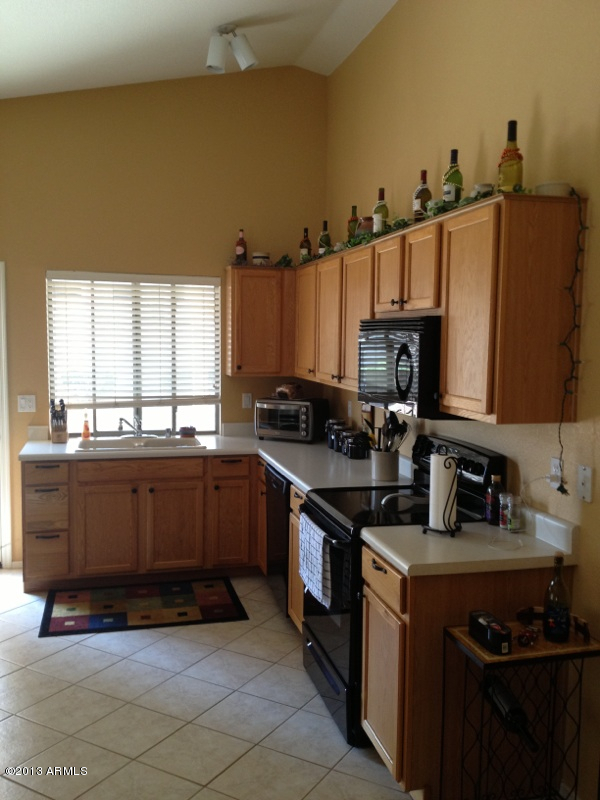 635 West Colt Road Chandler, AZ 85225 - Photo 4 of 9 a kitchen with stainless steel appliances a stove a sink and a microwave