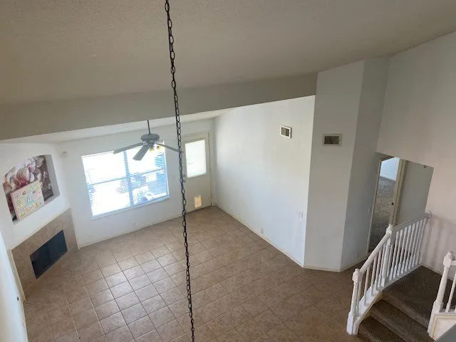 a view of empty room with window and fireplace