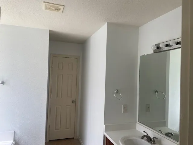 a bathroom with a shower and a sink
