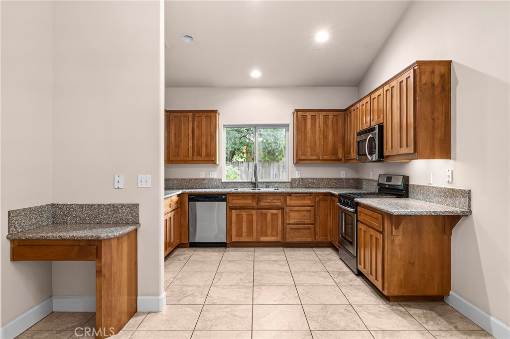 3 Sunflower Court Chico, CA 95926 - Photo 11 of 40 a kitchen with stainless steel appliances granite countertop a sink stove and cabinets