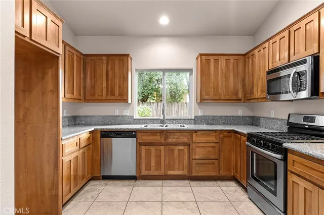 a kitchen with a stove sink and cabinets