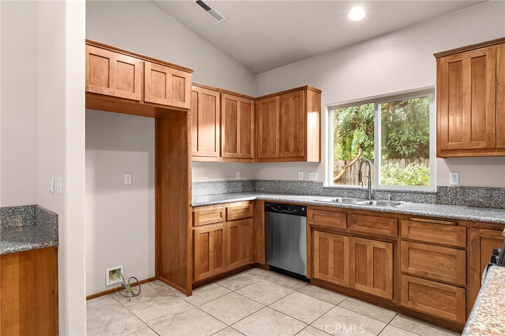 3 Sunflower Court Chico, CA 95926 - Photo 13 of 40 a kitchen with stainless steel appliances granite countertop a refrigerator and wooden cabinets