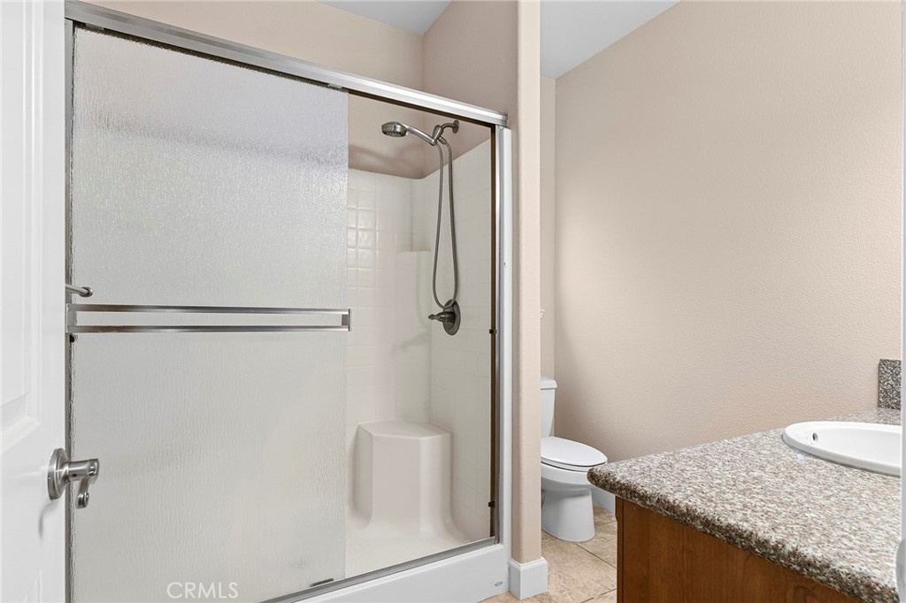 3 Sunflower Court Chico, CA 95926 - Photo 23 of 40 a bathroom with a granite countertop shower and a toilet