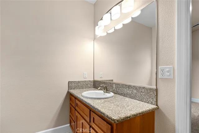 a bathroom with a sink a mirror and a light fixture