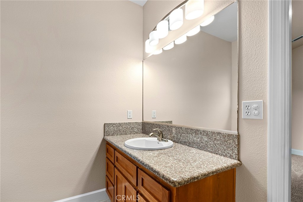 3 Sunflower Court Chico, CA 95926 - Photo 24 of 40 a bathroom with a sink a mirror and a light fixture