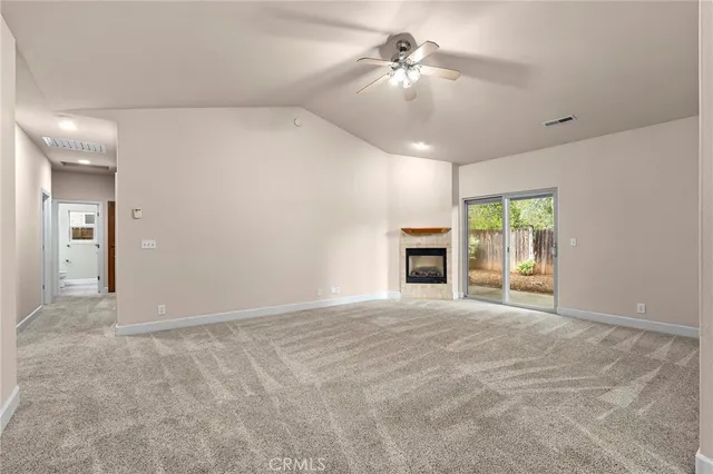 an empty room with fan and windows