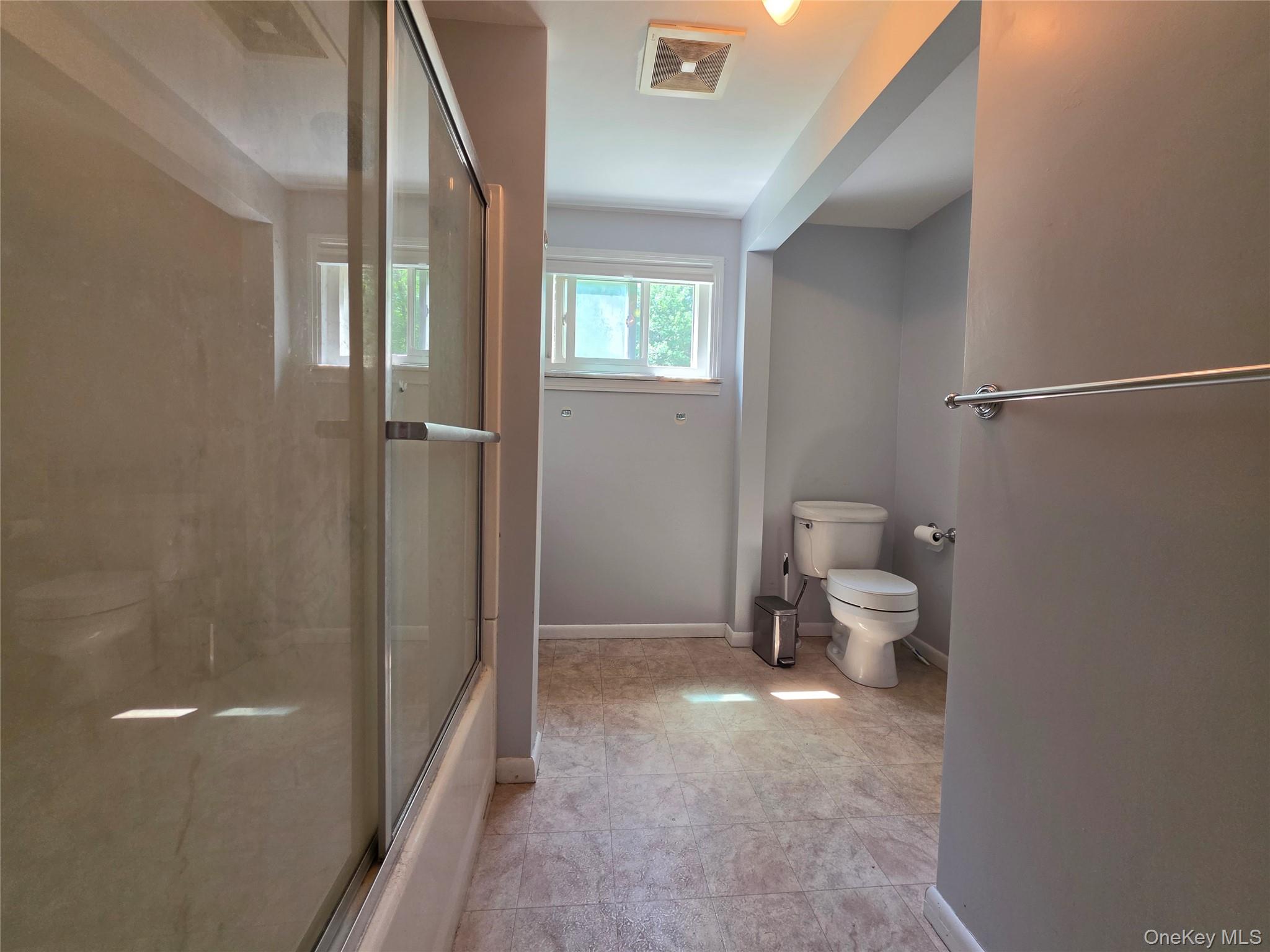 4804 Country Club Road Vestal, NY 13850 - Photo 12 of 15 a bathroom with a toilet and a shower