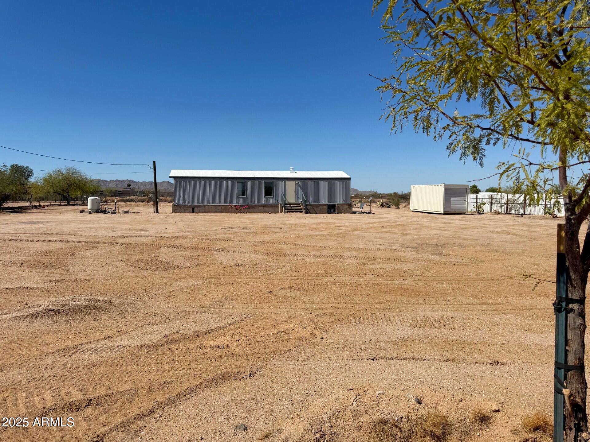 373 South Amarillo Valley Road Maricopa, AZ 85139 - Photo 21 of 23 a large white building with trees in front of it