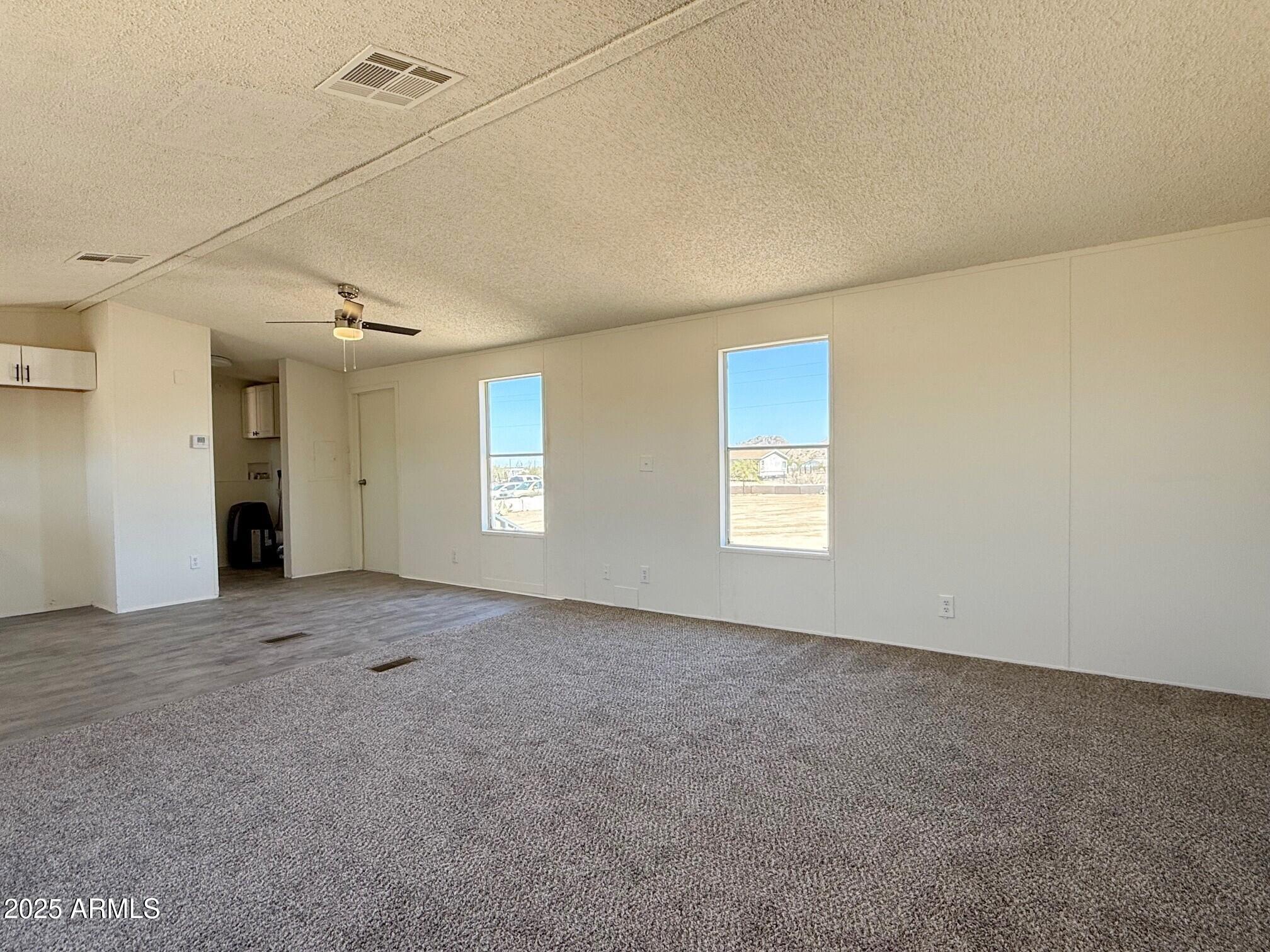 373 South Amarillo Valley Road Maricopa, AZ 85139 - Photo 8 of 23 an empty room with windows