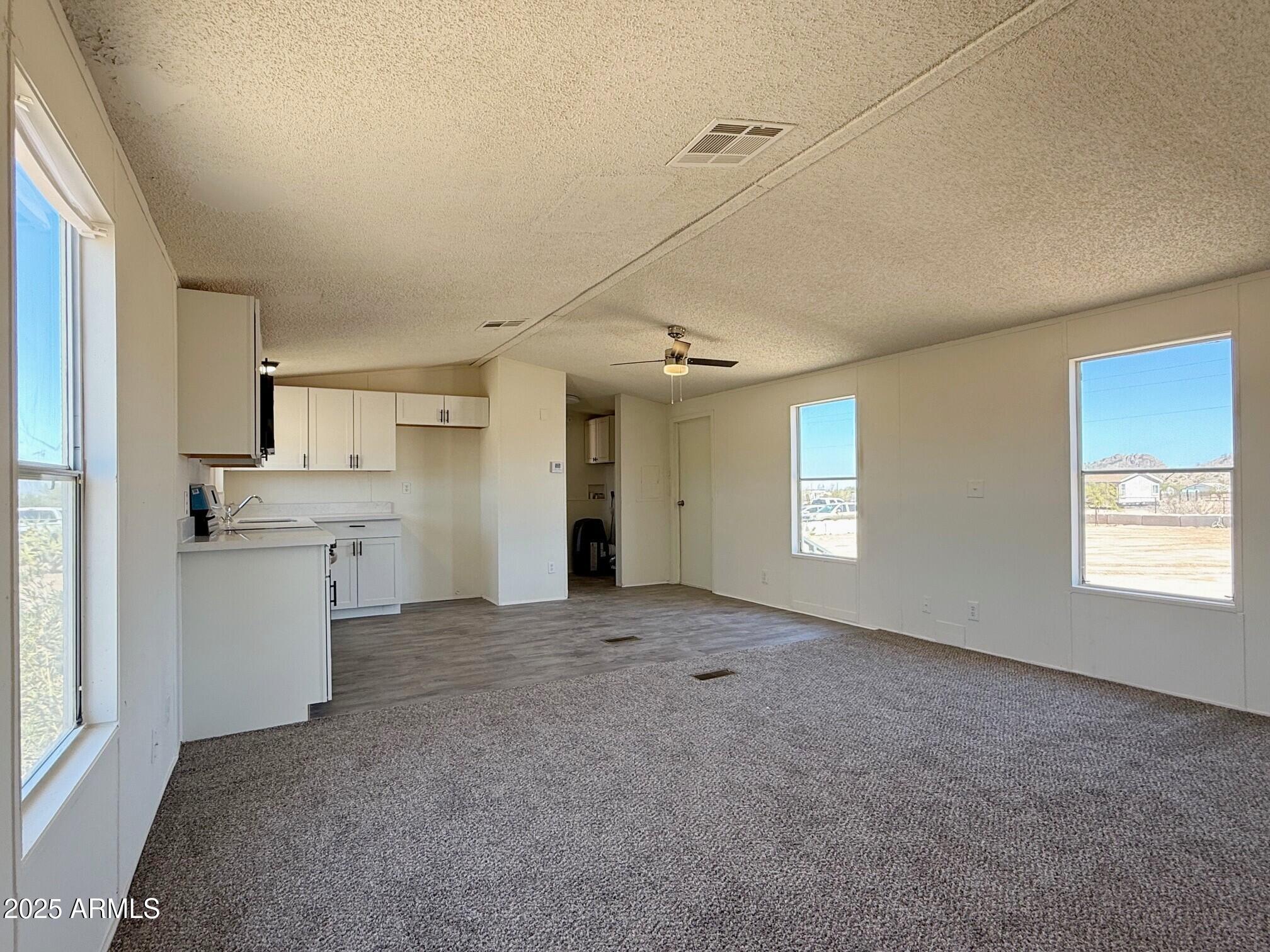373 South Amarillo Valley Road Maricopa, AZ 85139 - Photo 9 of 23 a view of a kitchen with a sink and a window