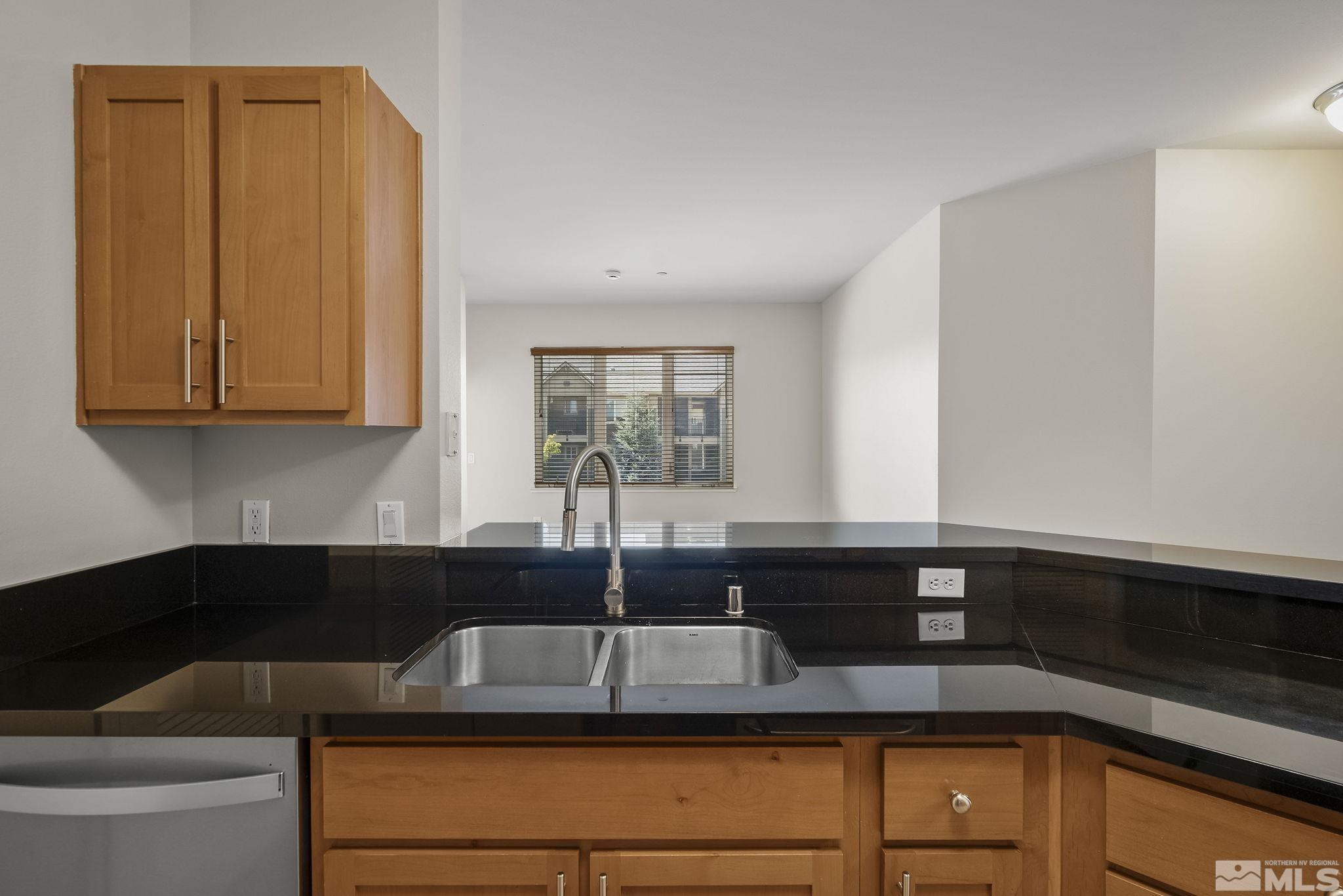 1450 Idlewild Drive, Unit 933 Reno, NV 89509 - Photo 11 of 32 a kitchen with a sink and cabinets
