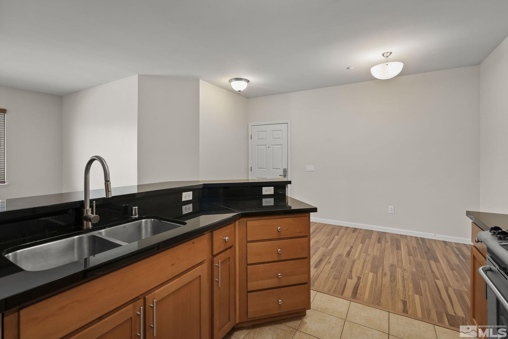 1450 Idlewild Drive, Unit 933 Reno, NV 89509 - Photo 12 of 32 a kitchen with granite countertop a sink and cabinets