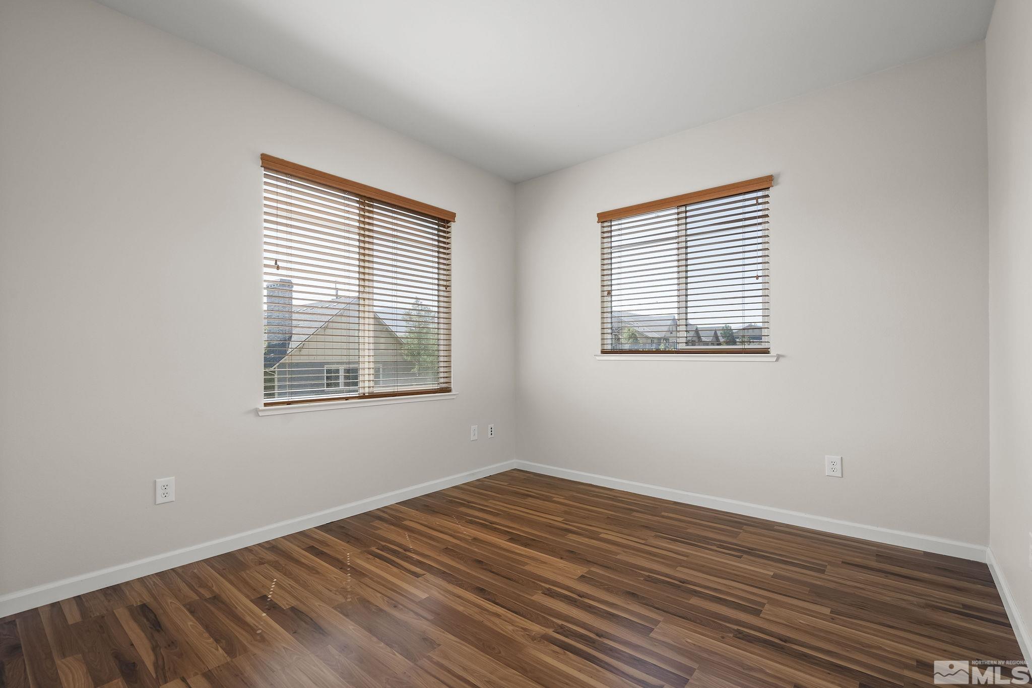1450 Idlewild Drive, Unit 933 Reno, NV 89509 - Photo 17 of 32 a view of an empty room with wooden floor and a window