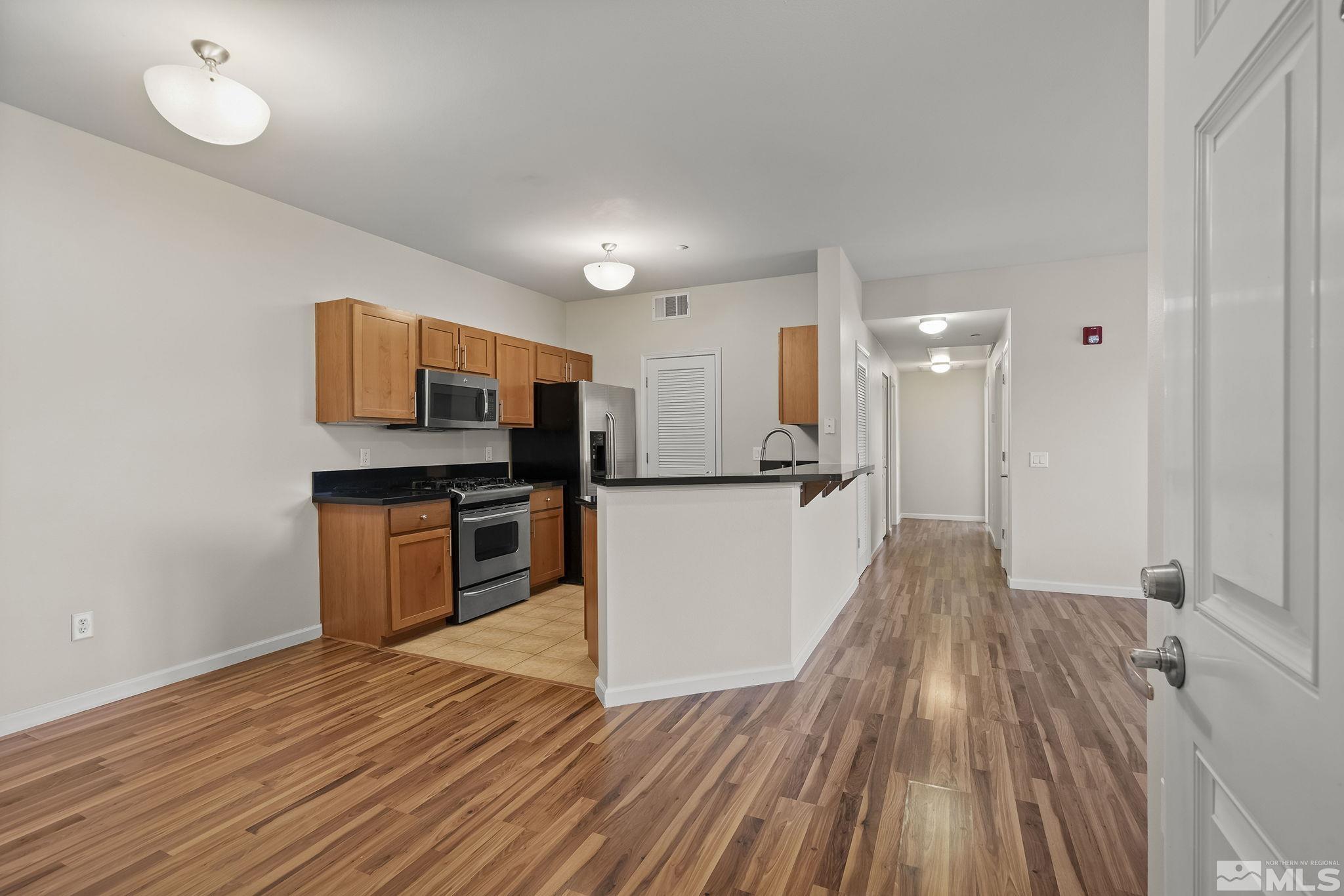 1450 Idlewild Drive, Unit 933 Reno, NV 89509 - Photo 2 of 32 a view of kitchen with sink microwave and refrigerator