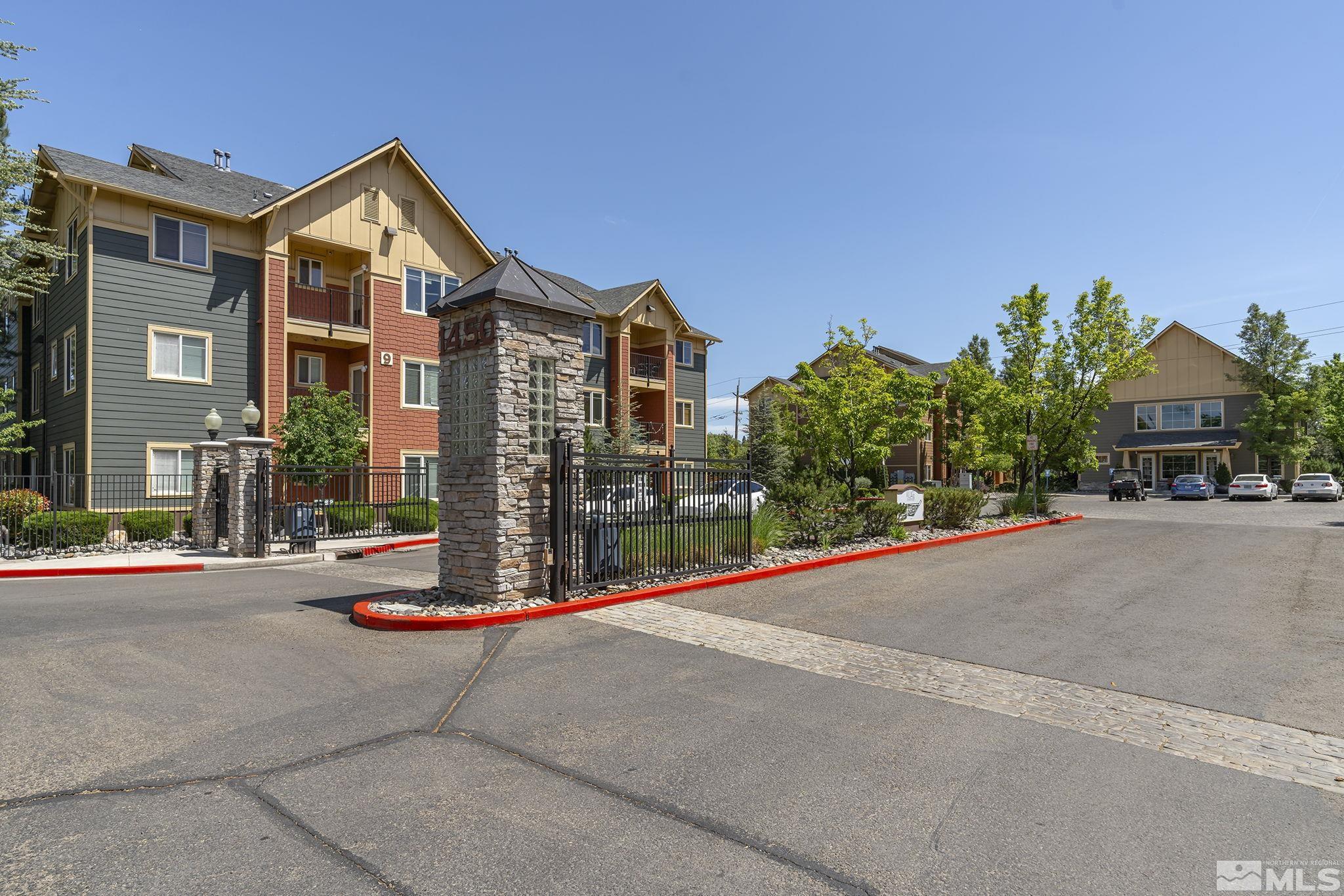 1450 Idlewild Drive, Unit 933 Reno, NV 89509 - Photo 31 of 32 a front view of a house with a yard and garage