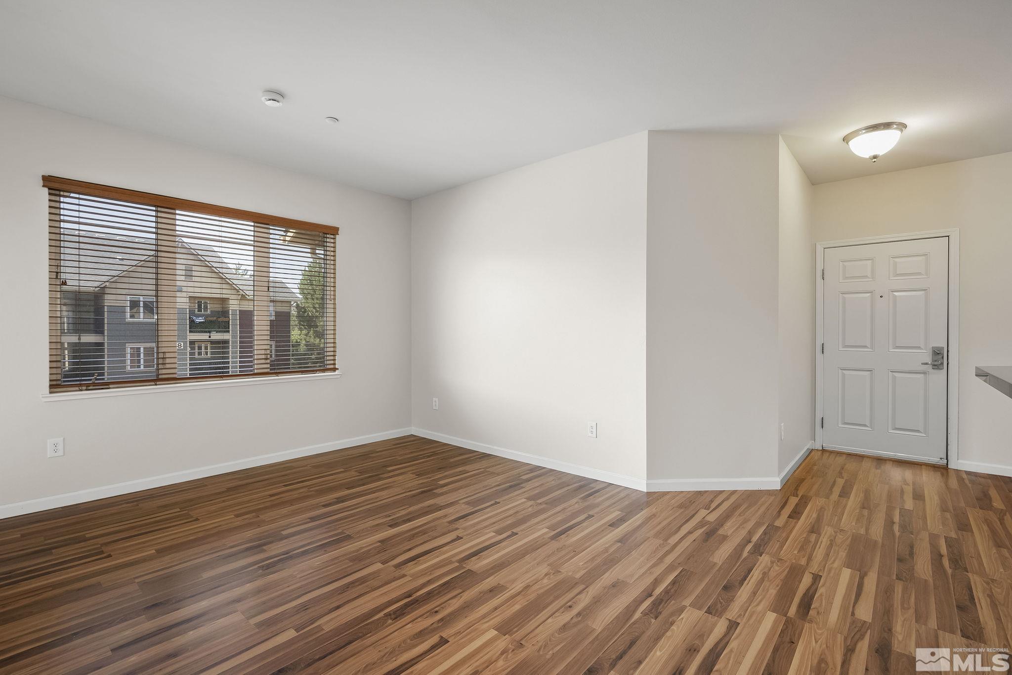 1450 Idlewild Drive, Unit 933 Reno, NV 89509 - Photo 4 of 32 a view of empty room with wooden floor and fan