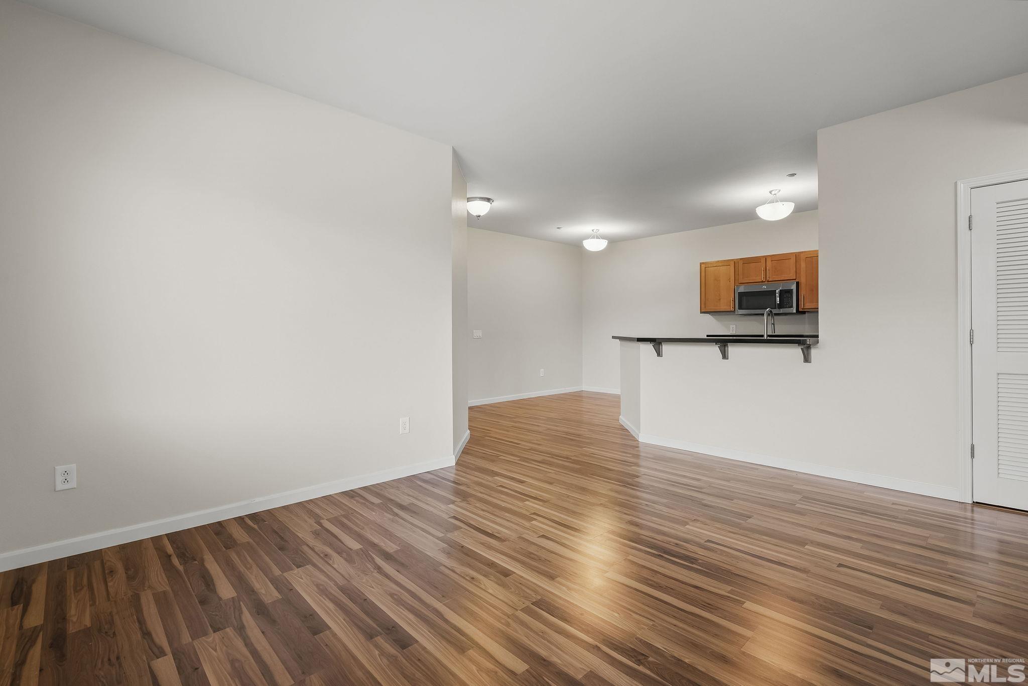 1450 Idlewild Drive, Unit 933 Reno, NV 89509 - Photo 7 of 32 a view of empty room with wooden floor