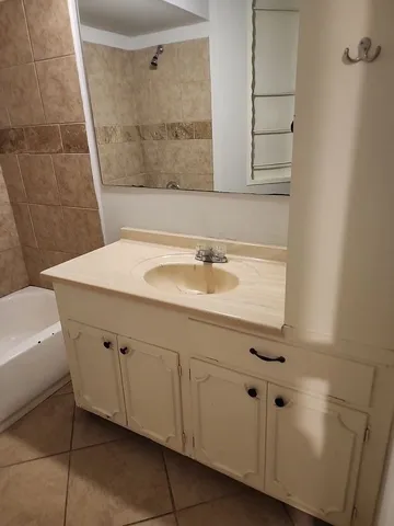 a bathroom with a bathtub and shower