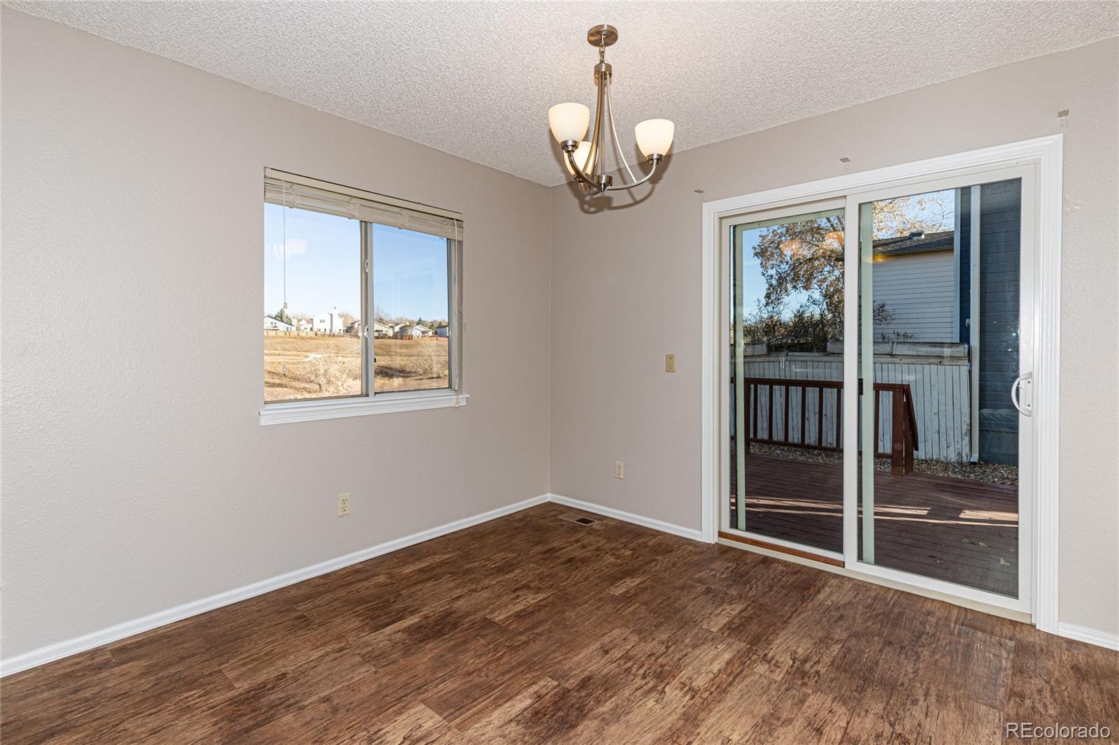 9498 Pendleton Drive Highlands Ranch, CO 80126 - Photo 16 of 28 a view of empty room with wooden floor
