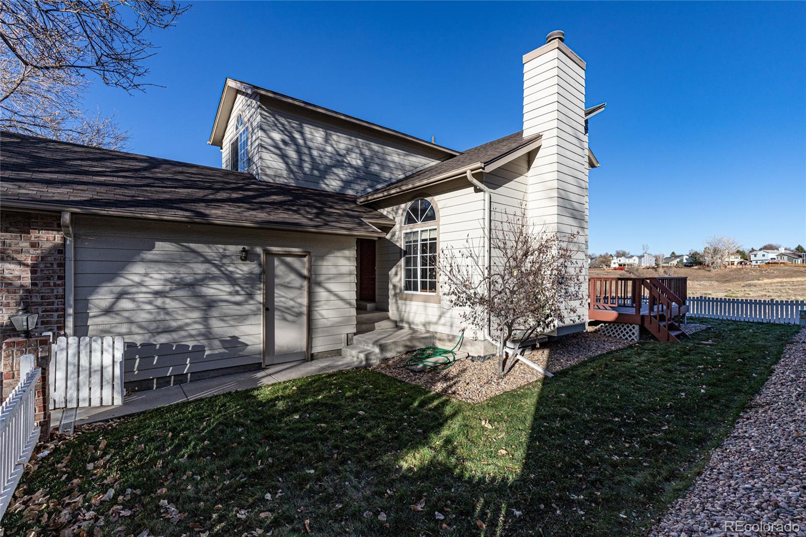 9498 Pendleton Drive Highlands Ranch, CO 80126 - Photo 2 of 28 a backyard of a house with lots of green space