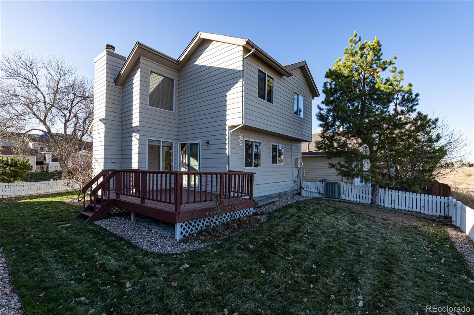 9498 Pendleton Drive Highlands Ranch, CO 80126 - Photo 3 of 28 a view of a house with a yard and deck