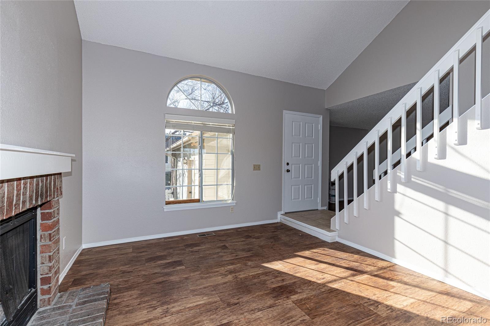 9498 Pendleton Drive Highlands Ranch, CO 80126 - Photo 4 of 28 a view of an empty room with wooden floor and a window