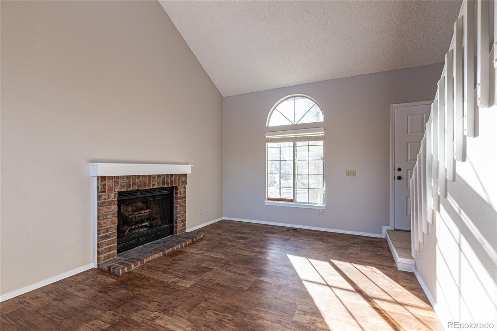 9498 Pendleton Drive Highlands Ranch, CO 80126 - Photo 6 of 28 an empty room with windows and fireplace