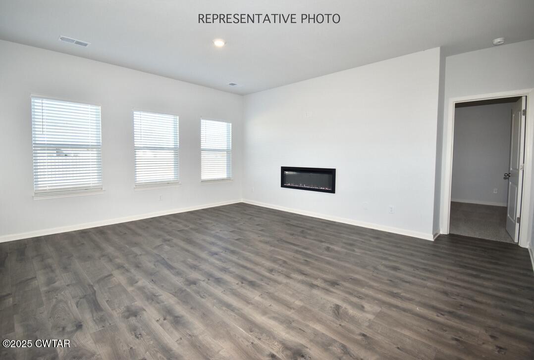 39 Kings Gate Cove Jackson, TN 38305 - Photo 1 of 19 an empty room with wooden floor and windows
