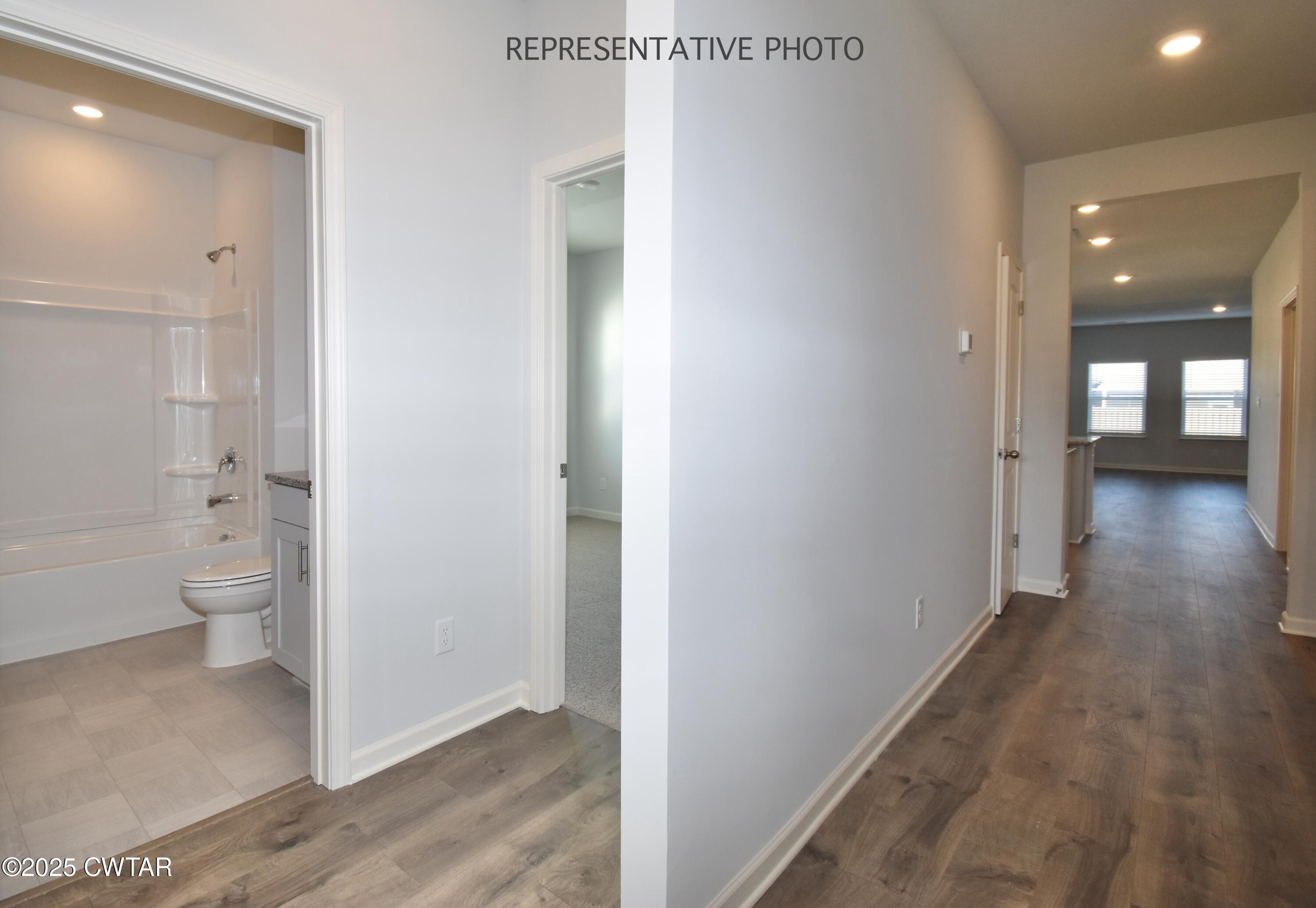 39 Kings Gate Cove Jackson, TN 38305 - Photo 14 of 19 a view of a hallway with wooden floor and a bathroom
