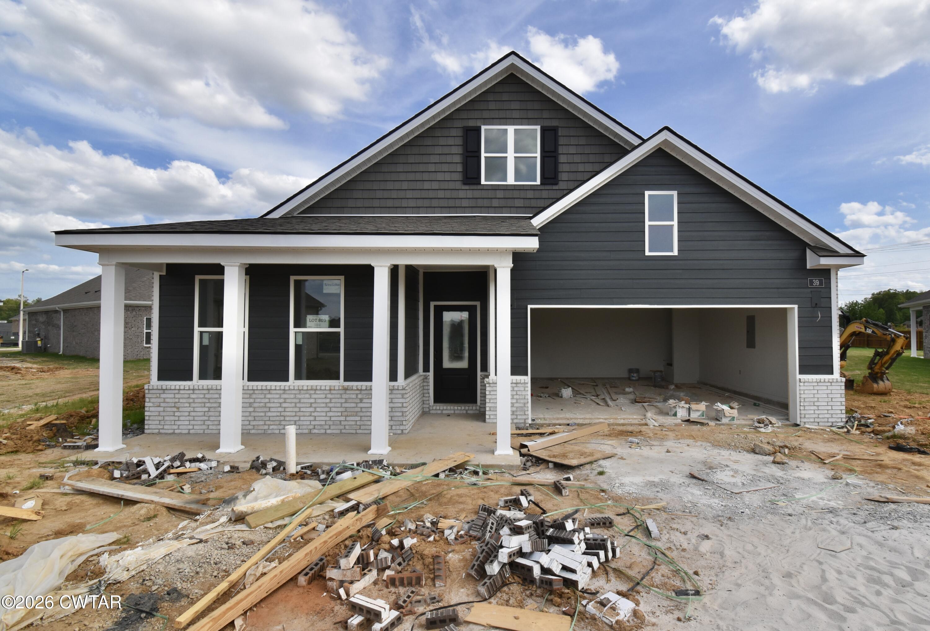 39 Kings Gate Cove Jackson, TN 38305 - Photo 18 of 19 a front view of a house with a yard and garage