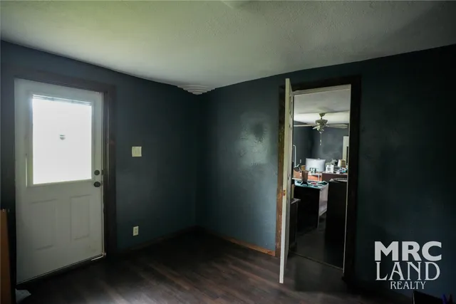 an empty room with wooden floor and closet