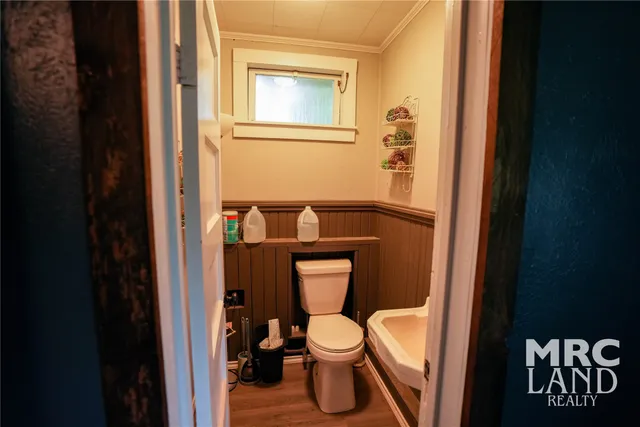 a white toilet sitting next to a bathroom sink