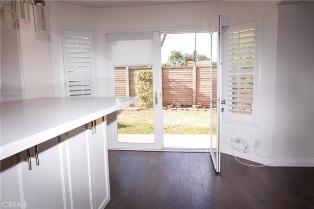 a view of an entryway with wooden floor