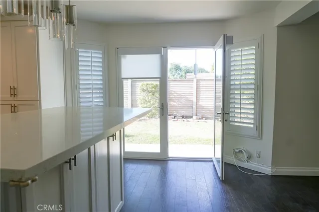 a view of an entryway with wooden floor and windows