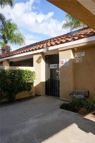 a front view of a house with plants