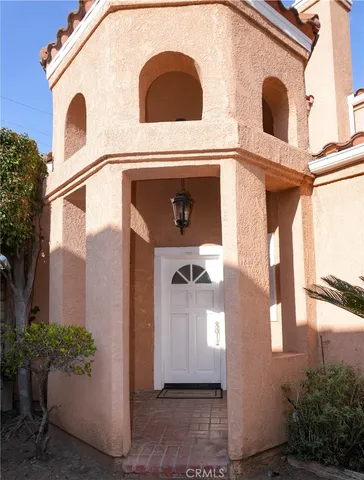a view of a front of house with a potted plants