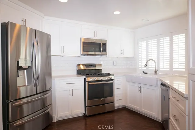 a kitchen with a refrigerator stove and sink
