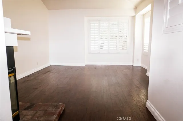 a view of a room with wooden floor and a window
