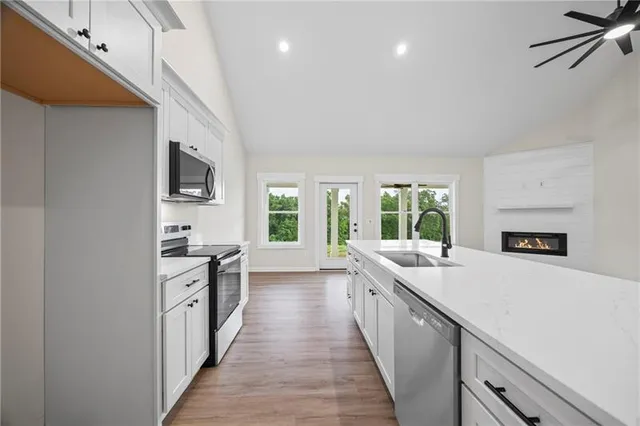 a large white kitchen with a large window