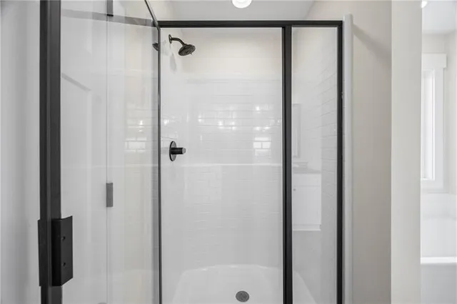a bathroom with a glass shower door