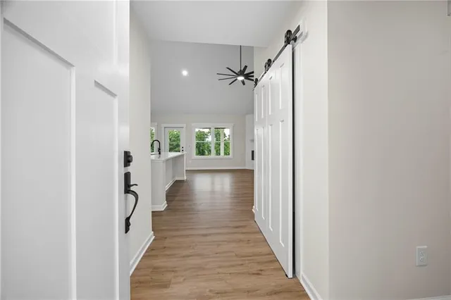 a view of a hallway with wooden floor and staircase