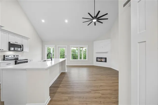 a view of workspace with wooden floor and a window