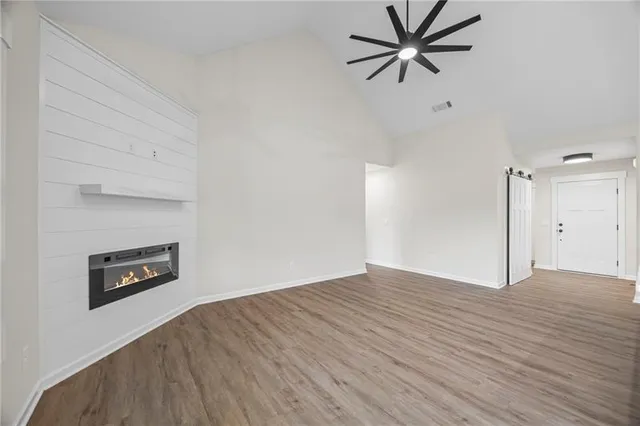 a view of a livingroom with a hardwood floor and a ceiling fan
