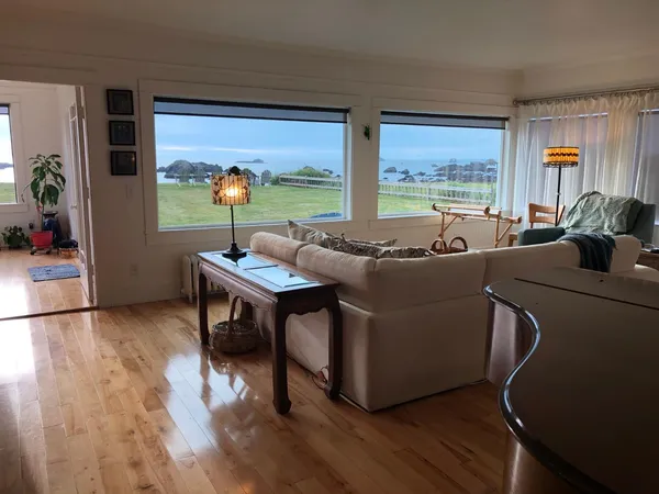 a view of a dining room with furniture wooden floor and a rug