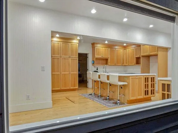 a dining room with furniture and wooden floor