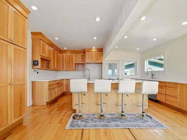 a dining room with furniture and wooden floor