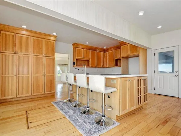 a view of a dining room with furniture a chandelier and wooden floor