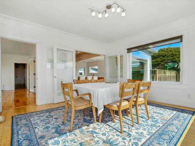 183 Lighthouse Way Crescent City, CA 95531 - Photo 34 of 87 a dining room with wooden floor a chandelier a wooden table and chairs