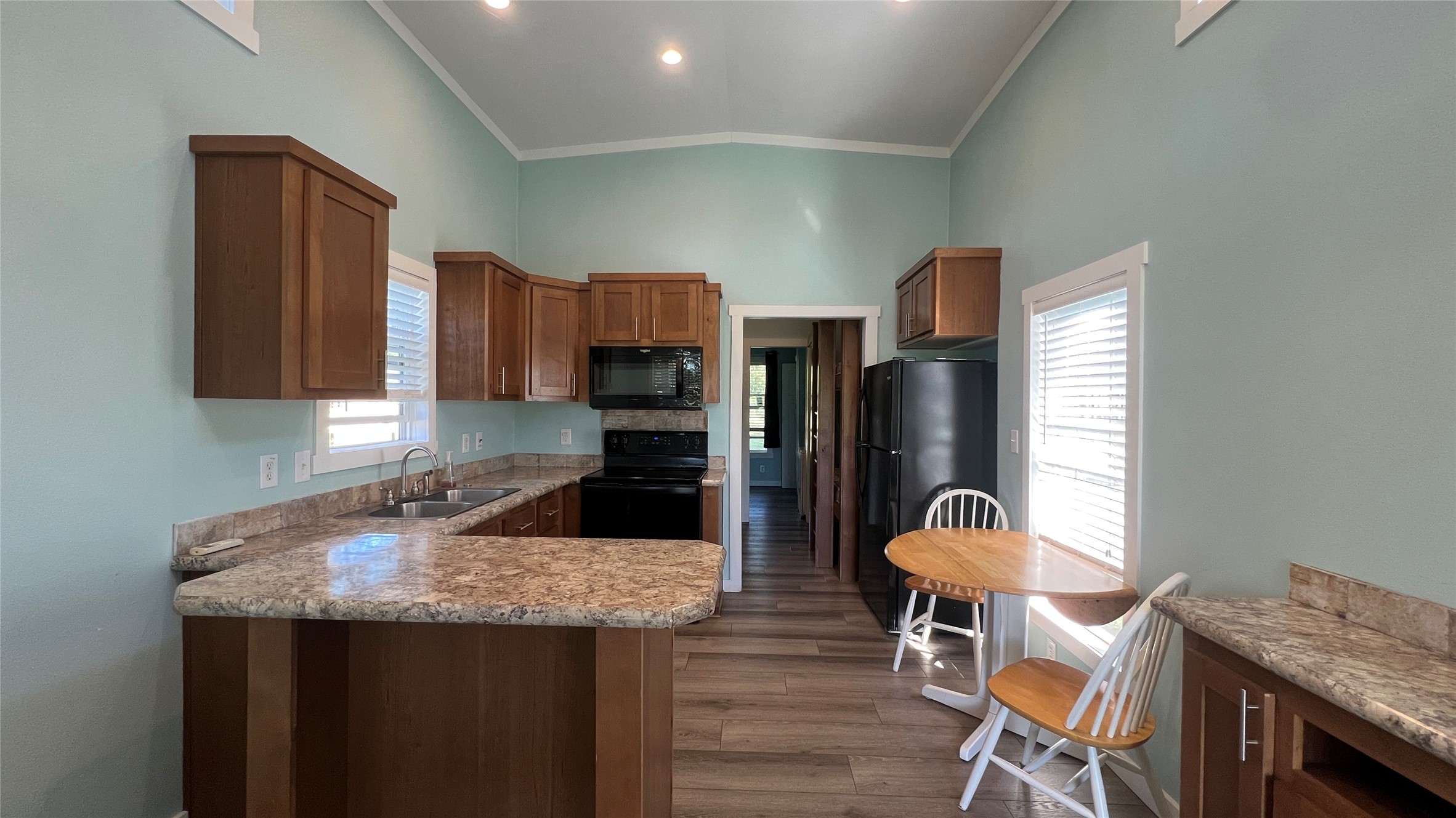 103 Pitts Road, Unit C Richmond, TX 77406 - Photo 1 of 7 a kitchen with granite countertop kitchen island stainless steel appliances a refrigerator a stove a sink cabinets and a dining table